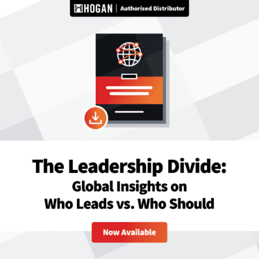 Graphic featuring a digital document with a globe icon and a download symbol, accompanied by the text "The Leadership Divide: Global Insights on Who Leads vs. Who Should." The header states "HOGAN | Authorised Distributor," and there is a button labeled "Now Available" at the bottom. The background consists of geometric shapes in light colors.